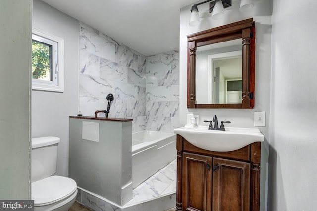 bathroom with vanity, toilet, and a bathtub