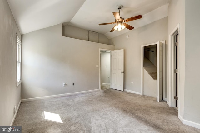 unfurnished bedroom featuring lofted ceiling, light carpet, and ceiling fan