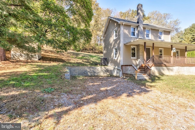 rear view of property featuring covered porch and central air condition unit