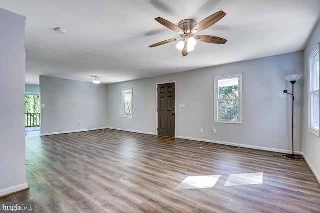 unfurnished room with ceiling fan and dark hardwood / wood-style flooring