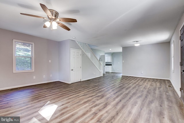 unfurnished living room with ceiling fan and light hardwood / wood-style floors