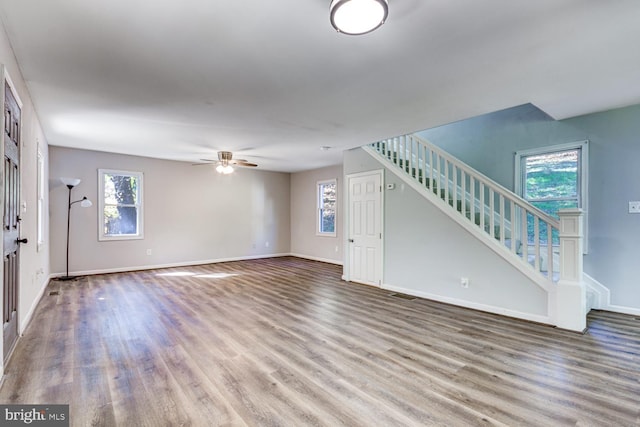 unfurnished living room featuring ceiling fan and wood-type flooring