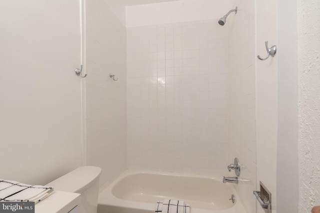 bathroom with toilet and shower / bathing tub combination