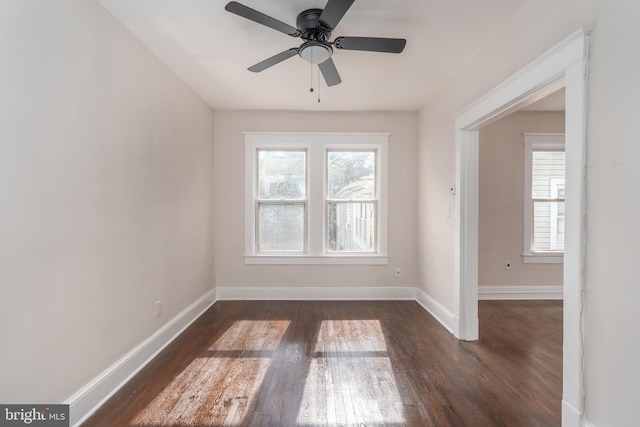 empty room with dark hardwood / wood-style floors and ceiling fan