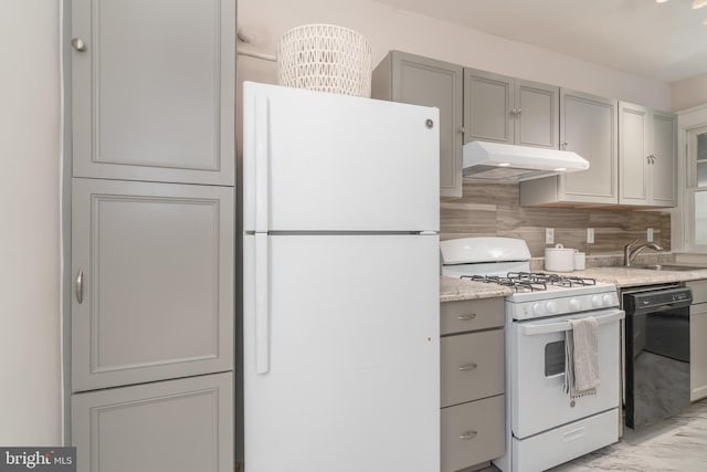 kitchen with sink, gray cabinets, white appliances, light stone countertops, and decorative backsplash