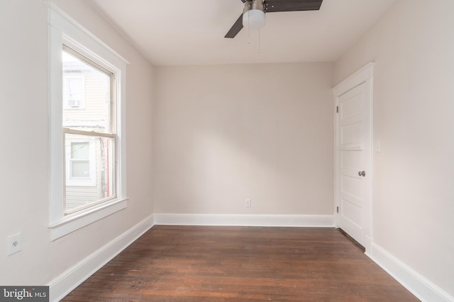 spare room featuring ceiling fan and dark hardwood / wood-style flooring