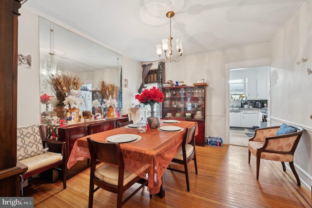 dining room with a chandelier and light hardwood / wood-style flooring