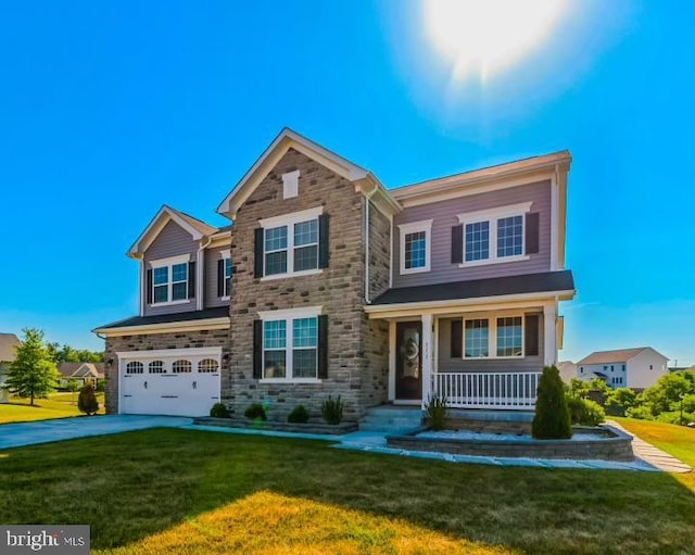 view of front of home featuring a garage, a front lawn, and covered porch