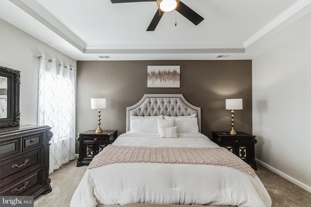 carpeted bedroom featuring ornamental molding, a raised ceiling, and ceiling fan