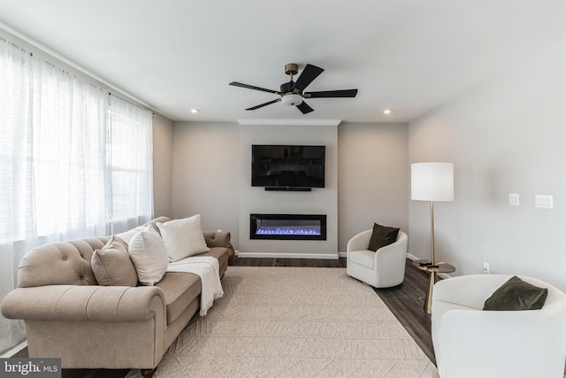 living room with ceiling fan and light hardwood / wood-style floors