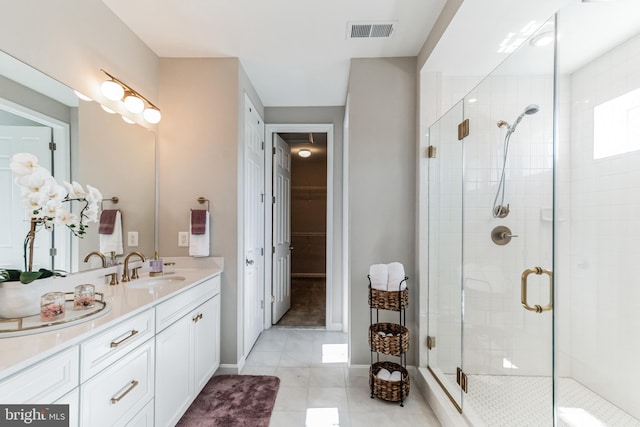 bathroom featuring vanity, an enclosed shower, and tile patterned flooring