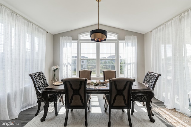 dining area with lofted ceiling and hardwood / wood-style floors