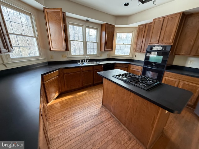 kitchen featuring a healthy amount of sunlight, black gas stovetop, and sink