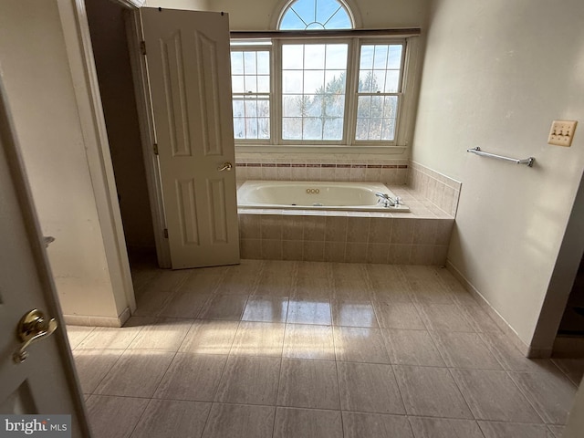 bathroom with a relaxing tiled tub