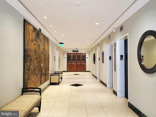 hallway with light tile patterned floors, baseboards, ornamental molding, and recessed lighting