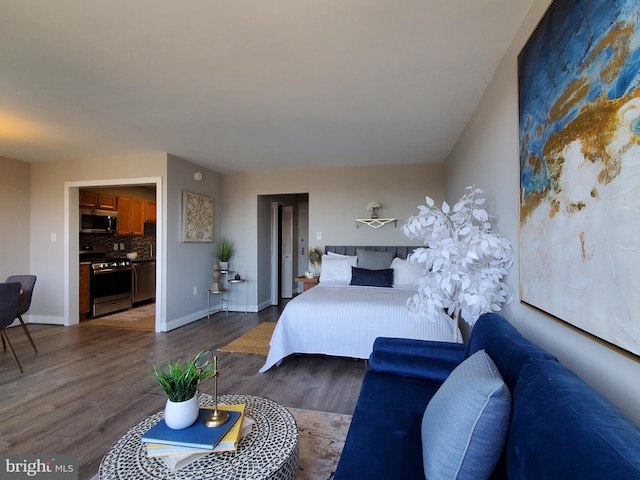 bedroom with wood finished floors and baseboards