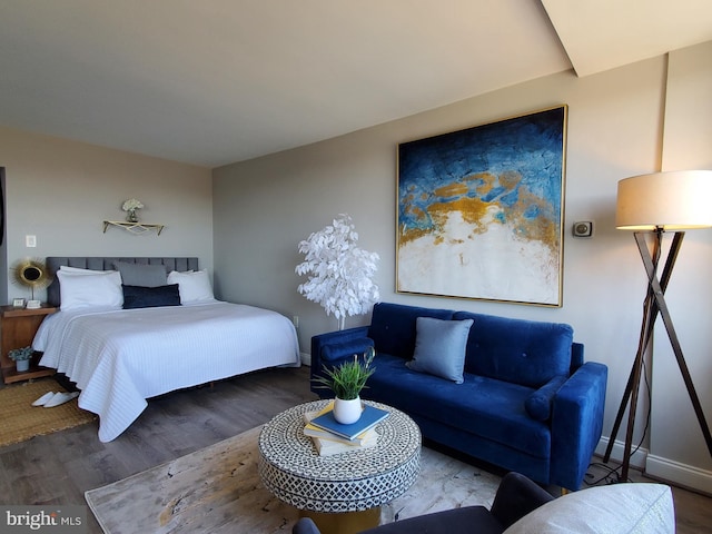 bedroom featuring baseboards and wood finished floors