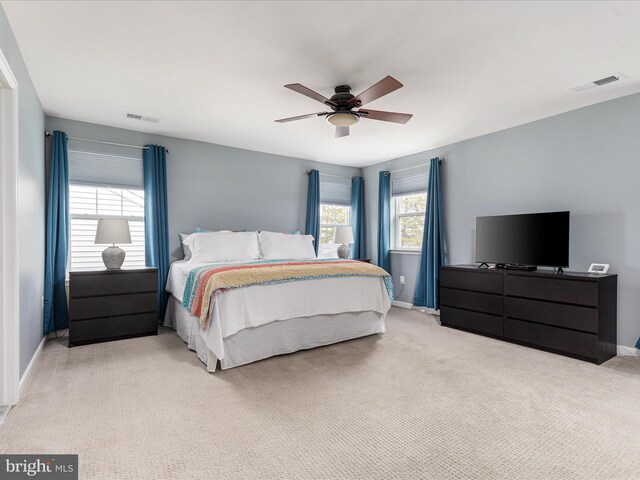 bedroom with light carpet and ceiling fan