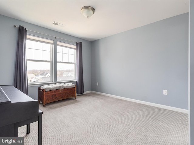 sitting room featuring light colored carpet