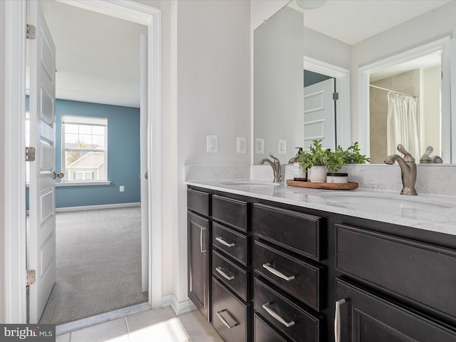 bathroom featuring tile patterned flooring and vanity