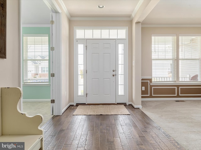 foyer with hardwood / wood-style flooring and ornamental molding