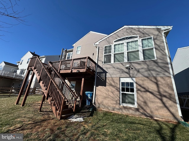 back of property with a yard and a deck