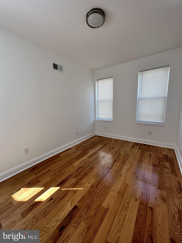 spare room with hardwood / wood-style floors