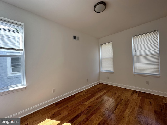 empty room with dark hardwood / wood-style floors