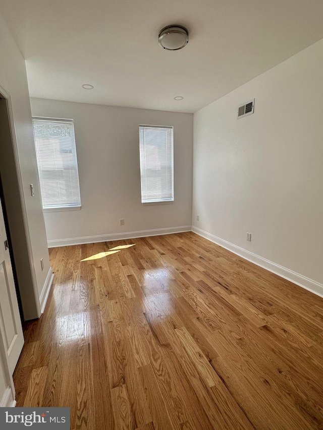 unfurnished room featuring a healthy amount of sunlight and light wood-type flooring