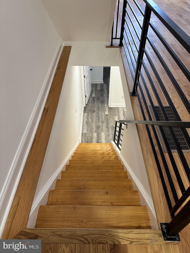 stairs with hardwood / wood-style floors