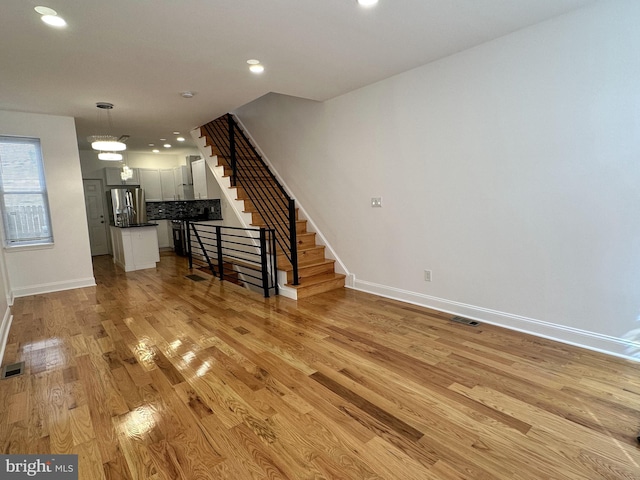 unfurnished living room featuring light wood-type flooring