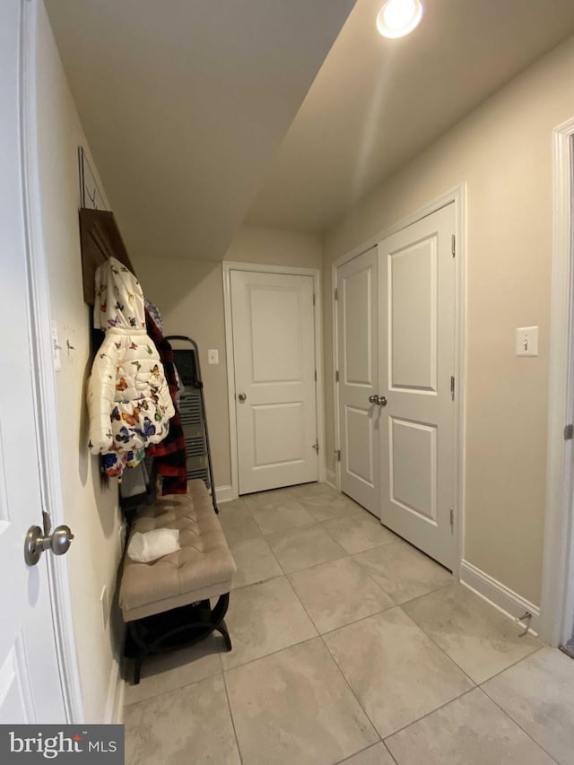 corridor featuring light tile patterned floors