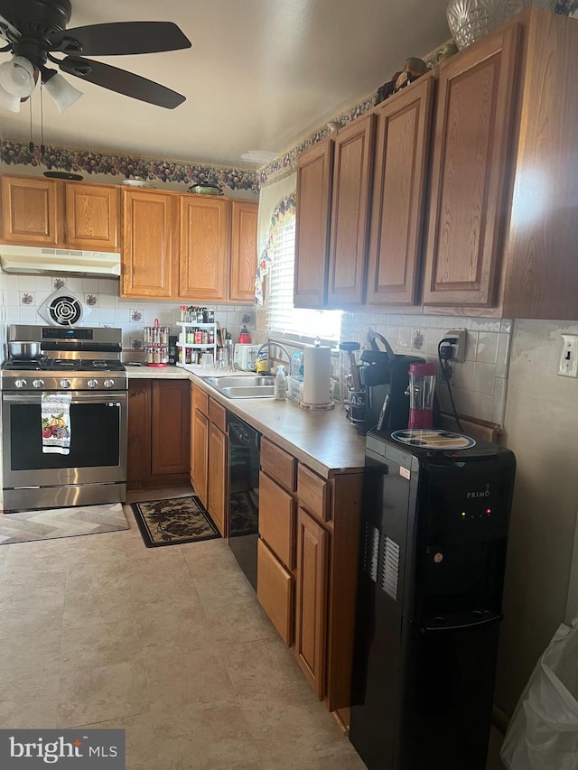 kitchen with sink, backsplash, stainless steel gas range, and ceiling fan