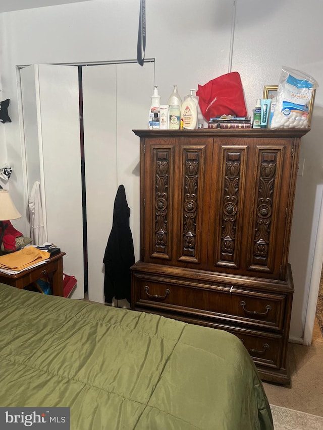 bedroom with light carpet and a closet