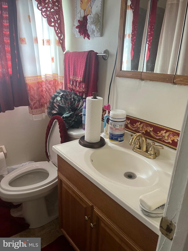 bathroom with vanity and toilet