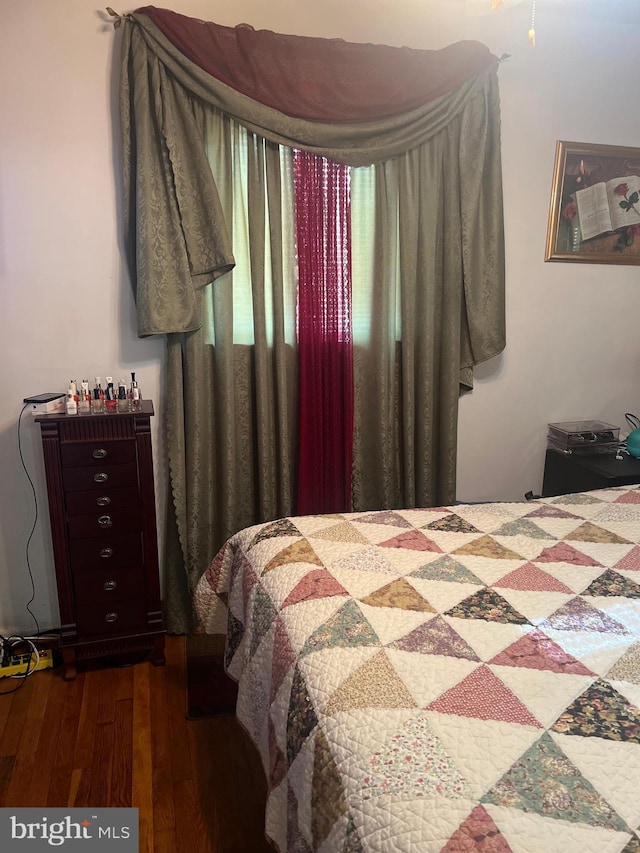 bedroom with hardwood / wood-style flooring