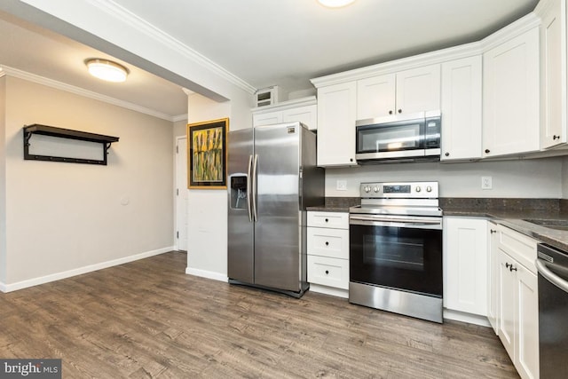 kitchen featuring dark wood-type flooring, sink, white cabinetry, crown molding, and stainless steel appliances