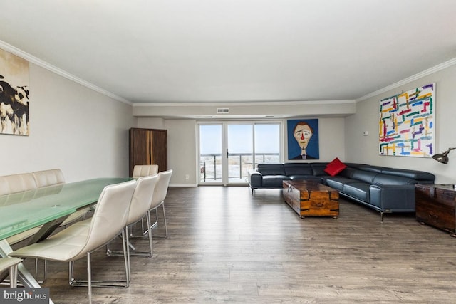 living room featuring wood-type flooring and ornamental molding