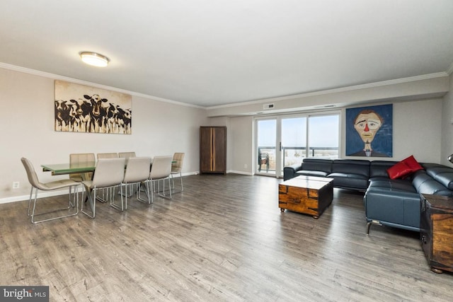 living room featuring wood-type flooring and crown molding