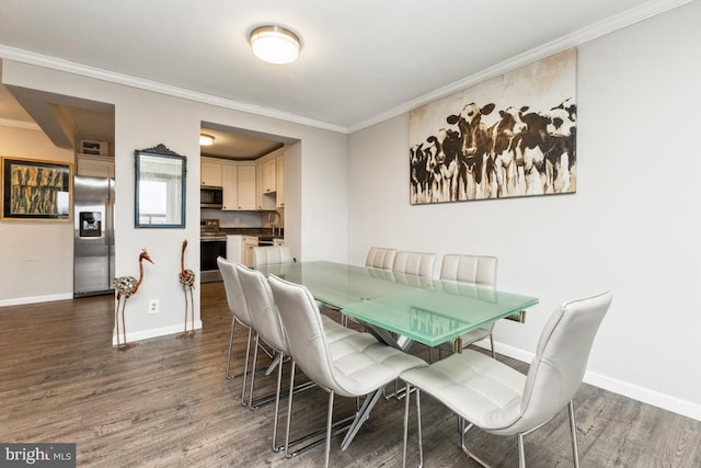 dining area with ornamental molding, dark hardwood / wood-style floors, and sink