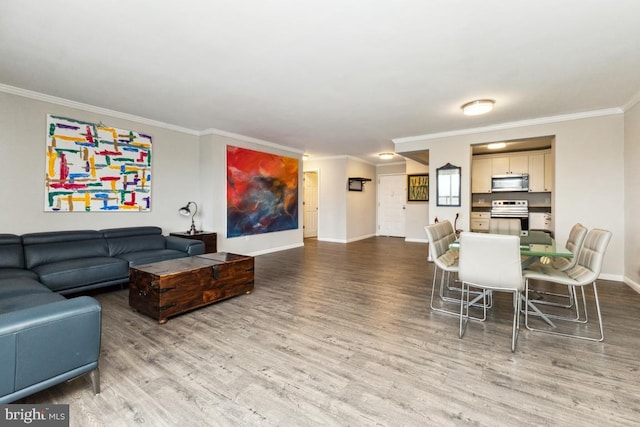 living room with hardwood / wood-style flooring and crown molding