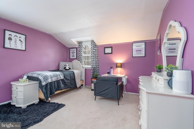 bedroom featuring vaulted ceiling and light colored carpet