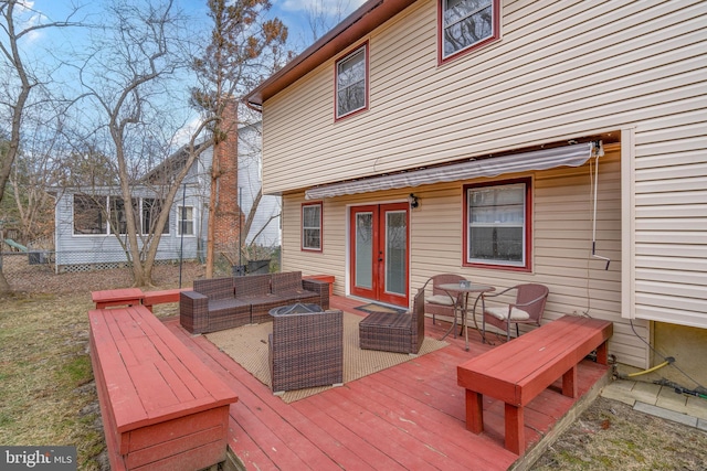 deck featuring an outdoor living space and french doors