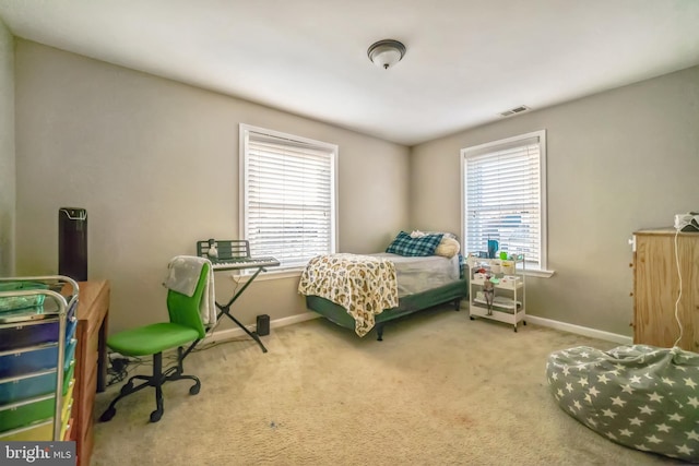 bedroom with multiple windows and carpet floors