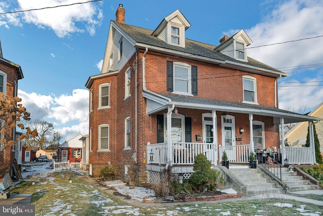 townhome / multi-family property featuring covered porch