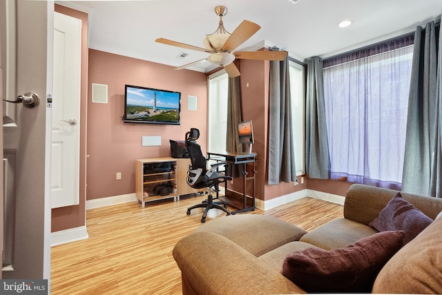 office space with light hardwood / wood-style floors and ceiling fan