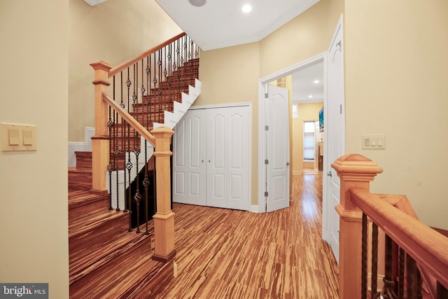 interior space with wood-type flooring and ornamental molding