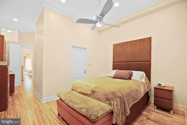 bedroom featuring ornamental molding, ceiling fan, and light wood-type flooring