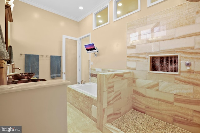 bathroom featuring tiled tub, crown molding, and tile patterned floors