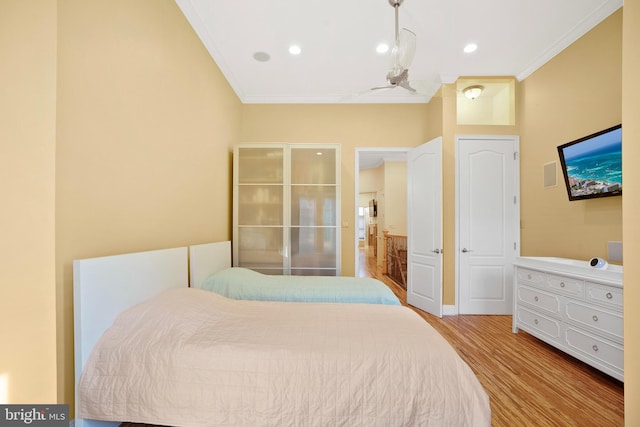 bedroom with crown molding and light hardwood / wood-style flooring